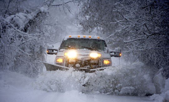 Elegant Landscaping truck plowing through heavy lake-effect snowstorm in Erie PA